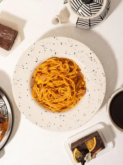 A "serving suggestion" shot, showing the Homesmith pasta bowl filled with spaghetti. This helps customers visualize using the product for their own meals.