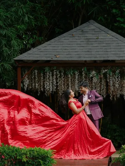 A dramatic shot of a flowing red dress at our garden gazebo, creating a stunning visual.