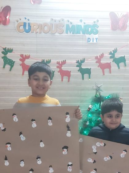 Two proud brothers showing off the snowman wrapping paper they helped create. It’s a wonderful feeling to make something useful and beautiful.