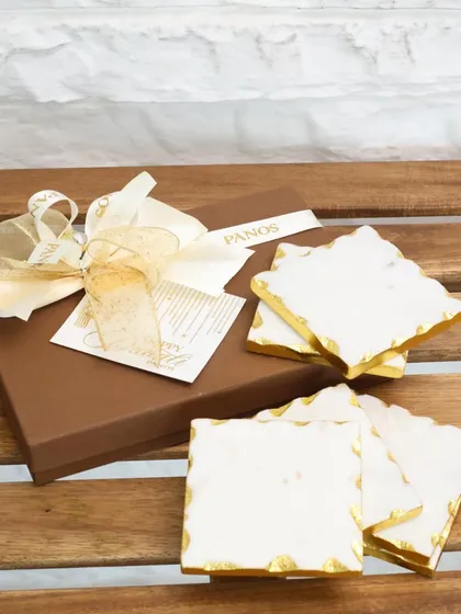 Our white marble coasters, packaged in a classic Panos gift box with a golden ribbon, offer a touch of everyday luxury. It is a perfect, ready-to-give present for any occasion.