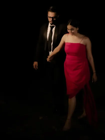 Another angle of the custom red high-low dress, showing how I styled the couple for a cohesive and sophisticated look. The simple elegance of the dress makes it a versatile piece for any celebration.
