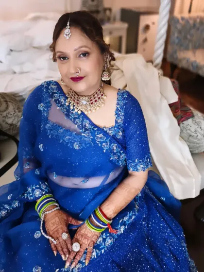 A portrait of timeless grace for the mother of the groom. This look features soft, defined eyes, a flattering berry lip color, and an elegant messy bun, enhancing her natural beauty for the wedding day.
