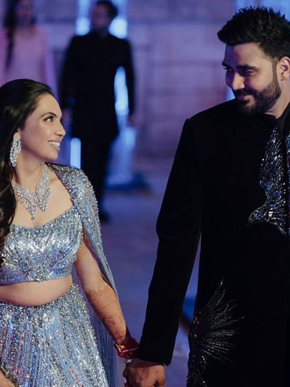 Nikita and Abhinav looking like a modern royal couple. His classic black sherwani with silver embroidery was the perfect match for her glamorous gown.