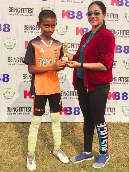 Recognizing talent from all teams. A player from Fast FC receives his "Player of the Match" award.
