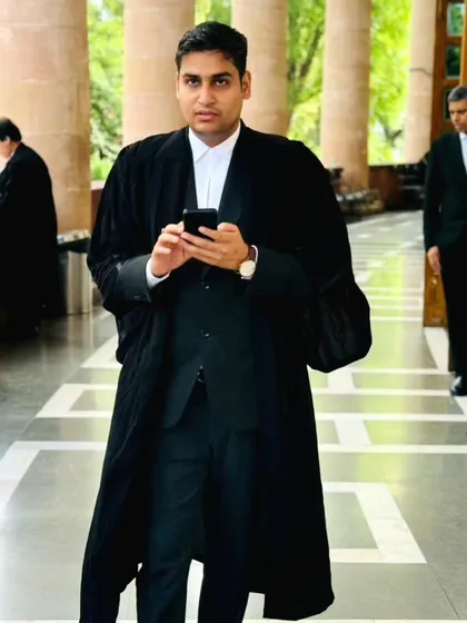 In the corridors of the court, dressed in my advocate's robes. This is my everyday environment, where I navigate the legal system to represent your interests effectively.
