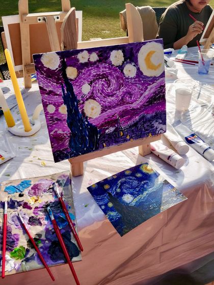 Another beautiful interpretation of "Starry Night" from our group painting event, showcasing a unique purple and blue color palette.