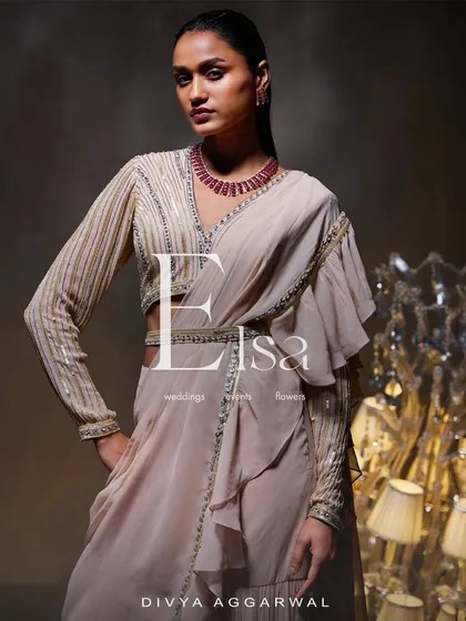 The Elsa Saree Set reimagines traditional elegance with its beautiful ruffle saree. I paired it with an intricately embellished long-sleeve blouse and a hand-adorned belt for a sophisticated look.