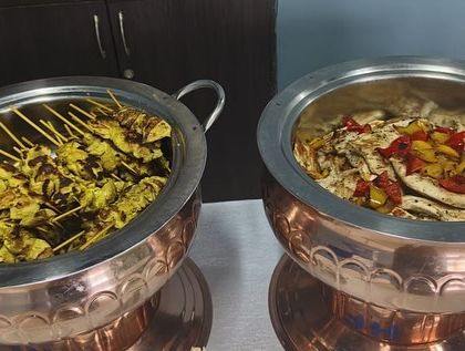 Our continental appetizers, featuring chicken satay skewers and a grilled chicken salad. We offer a diverse menu to cater to different tastes.