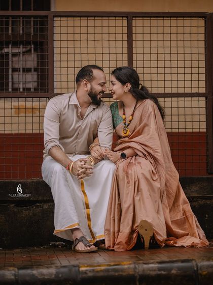 A sweet, seated portrait against a modern, geometric background, creating an interesting visual contrast.