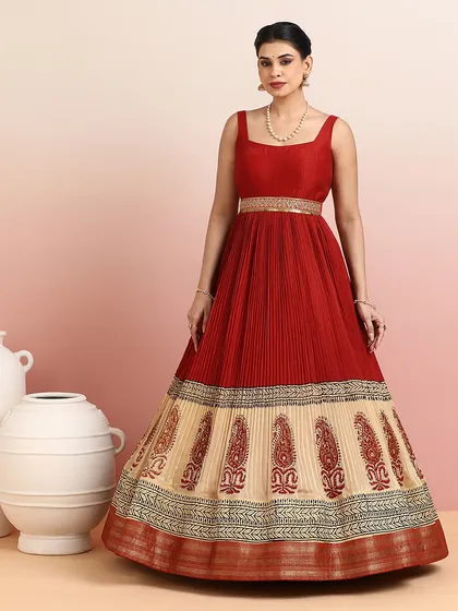 The full silhouette of the red and beige gown is both majestic and graceful, making it a perfect choice for a wedding reception or cultural event.