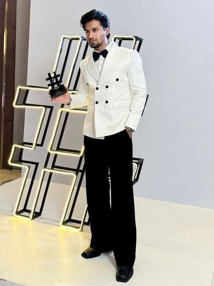 The full look of the custom white double-breasted tuxedo. The wide-leg trousers and perfect jacket length create a contemporary silhouette that is both elegant and fashionable.