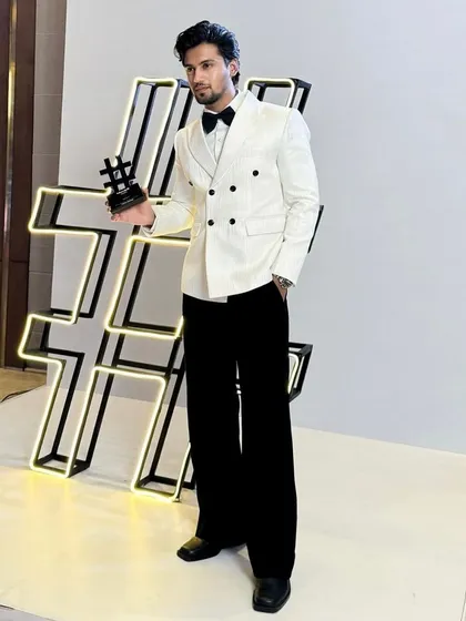 The full look of the custom white double-breasted tuxedo. The wide-leg trousers and perfect jacket length create a contemporary silhouette that is both elegant and fashionable.