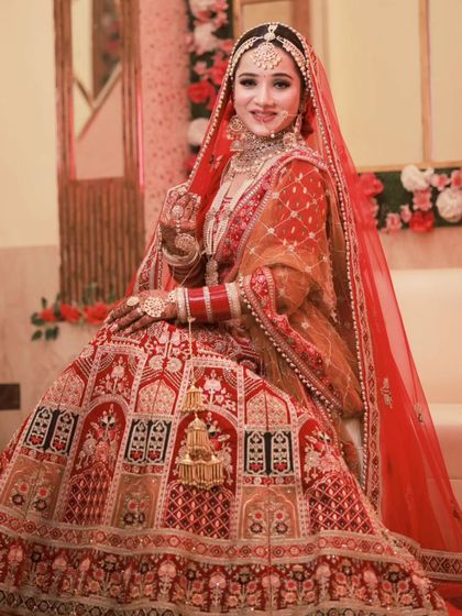 A full-length portrait of a happy bride. Her makeup is bright and fresh, with a focus on a radiant smile.