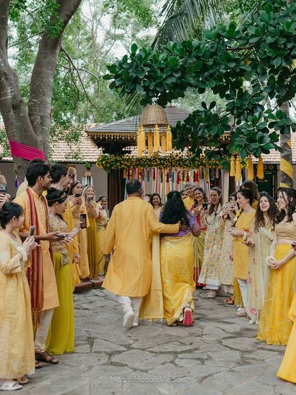 The bride's family makes a grand entrance, walking in a procession for the Haldi ceremony.