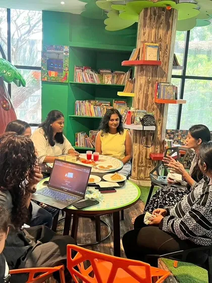 A parent using her laptop in our café. We make it easy to catch up on work with free Wi-Fi and a comfortable environment.