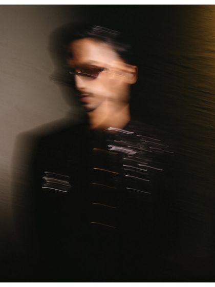 An abstract, motion-blur portrait of the groom. This artistic shot focuses on light and movement, creating a dynamic and modern image that feels like a painting.