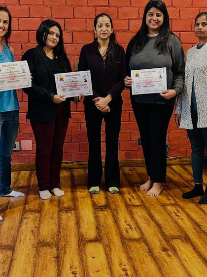 The proud moment of certification. After weeks of dedicated practice and study, these students are now certified yoga teachers, ready to share their knowledge with the world.