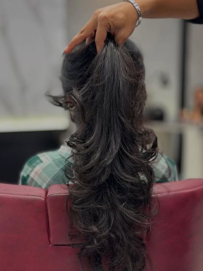 Holding up the hair shows the detail in the round layers. Each layer is cut to build volume and create a soft, rounded shape at the ends.