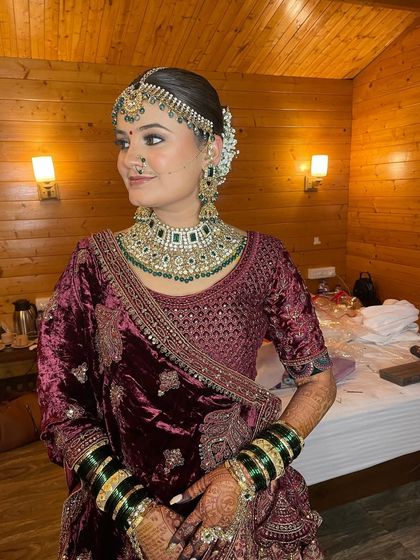 Showcasing the royal elegance of this bride's reception look, with soft glam makeup that complements her rich velvet lehenga.