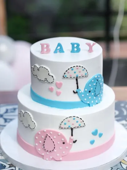 A client photo of our two-tier elephant baby shower cake, looking perfect at the celebration.