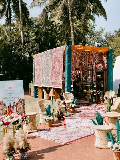 The entrance to the Moroccan-chic Haldi in Goa, featuring a welcome sign, boho seating, and a backdrop of rich, patterned rugs.