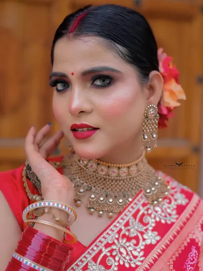 A beautiful close-up, capturing the model's direct gaze and vibrant red lipstick.