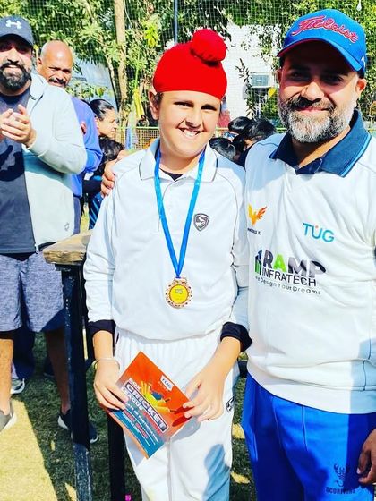 A coach with one of the champions from the Junior BCL team, Mafia 7. We take pride in our players' achievements.