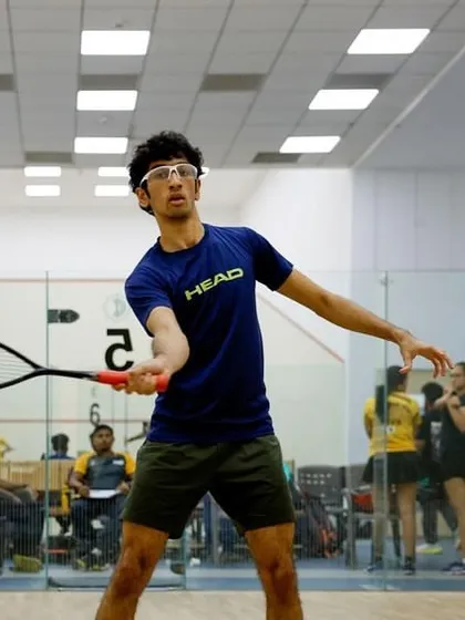 A player demonstrates perfect form and focus during a competitive rally at the SILA Inter-Club Championship.