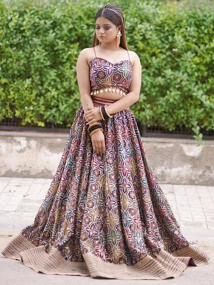 This printed, multi-color lehenga with a spaghetti-strap top is a fun and modern choice for a Mehendi or Haldi shoot. The twirling shots show its beautiful movement.