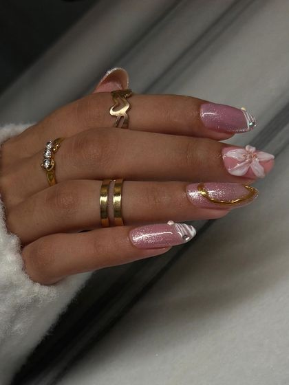 This set is all about texture and dimension. It combines a glittery pink base with a 3D sculpted flower, gold chrome accents, and white textured patterns for a look that is pure maximalist glam.