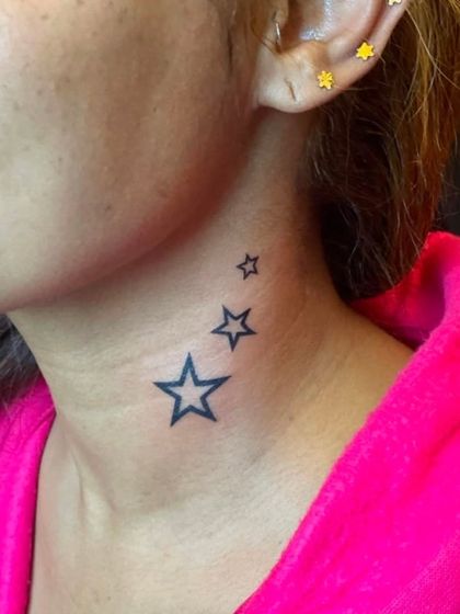 A trio of stars tattooed on the side of the neck.