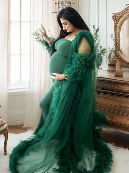 A touch of vintage elegance. This mother-to-be in a stunning green gown is pictured in a classic room setting, showcasing our new AI digital background capabilities.