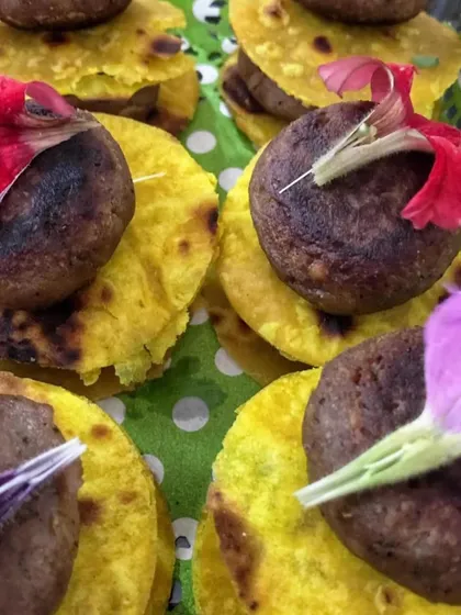 A close-up of my Galouti Kebabs served on mini saffron-infused parathas. Garnished with edible flowers, they are a feast for the eyes as well as the palate.