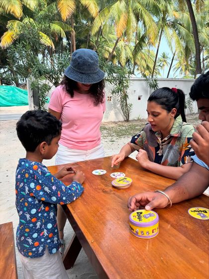 The fun doesn't stop out of the water. Enjoying some board games with the group during a surface interval. It's all about the community.