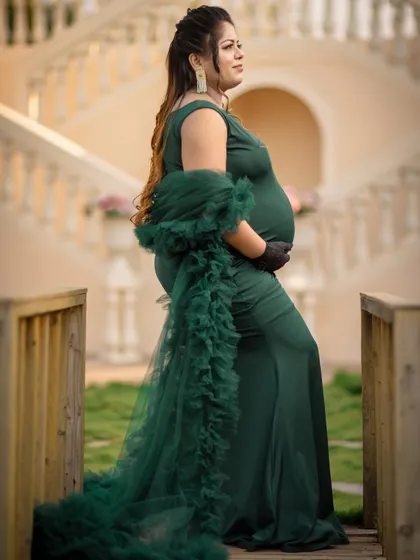 A profile shot is perfect for showcasing the beautiful curve of your baby bump. This elegant pose on a bridge highlights the mom-to-be's grace and strength.