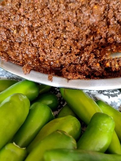 Preparing a fresh batch of Hari Mirch Bharwa pickle. You can see the fresh green chilies ready to be stuffed with my homemade masala paste.