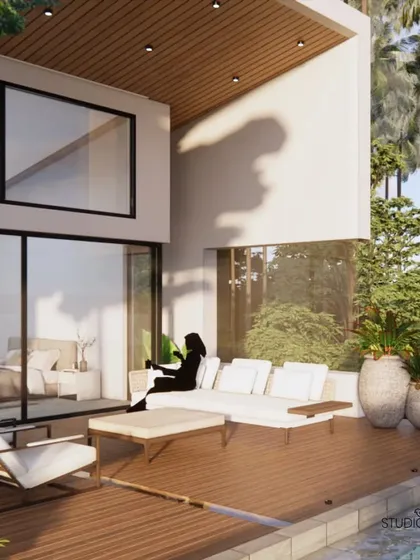 We designed this private deck for the Pai Residence as an extension of the bedroom. It offers a tranquil space for relaxation right by the infinity pool, surrounded by palm trees and overlooking the water, embodying luxury waterfront living.