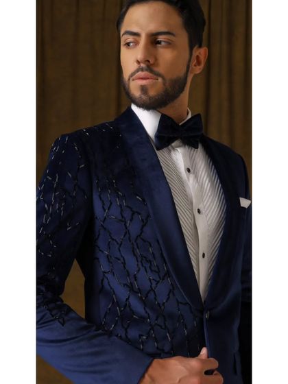 This image captures the luxurious feel of the Luxe Blue Velvet tuxedo. The black glass embellishments add a modern edge to the timeless sophistication of the velvet, perfect for any formal occasion.