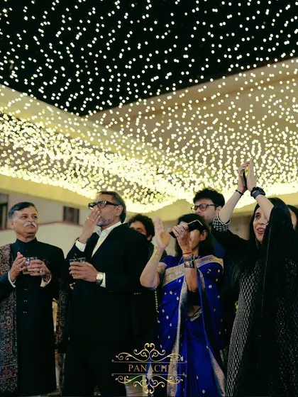 Guests enjoying the speeches and raising a toast to the happy couple.