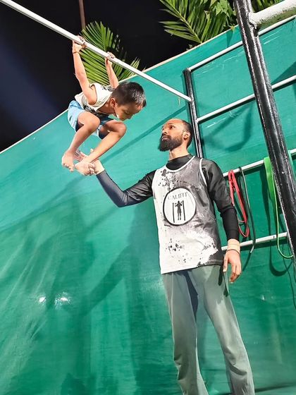 A coach and student share a moment of connection during training. We are here to lift our kids up, both literally and figuratively.