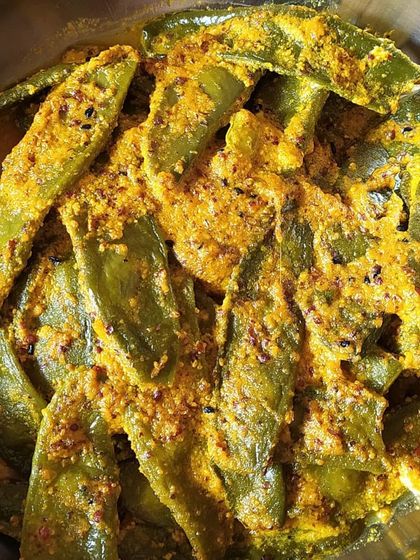 Sheem Shorshe, a zingy combination of flat beans cooked in a freshly ground mustard paste. The kick of mustard and fresh winter greens makes this a perfect side dish with steamed rice.
