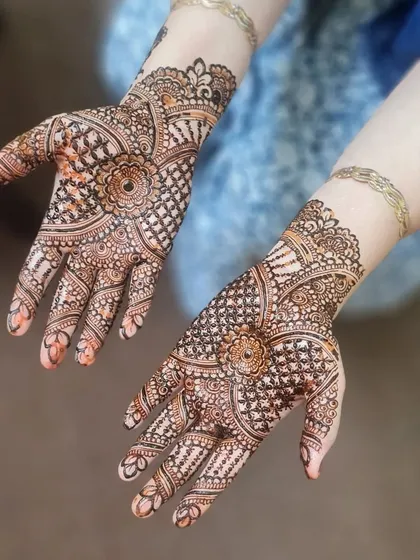 Both hands of the bridal design, showing the beautiful symmetry and complementary patterns.