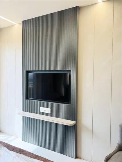 A still image of the sleek, wall-mounted TV unit in the bedroom, perfect for enjoying entertainment without cluttering the room.