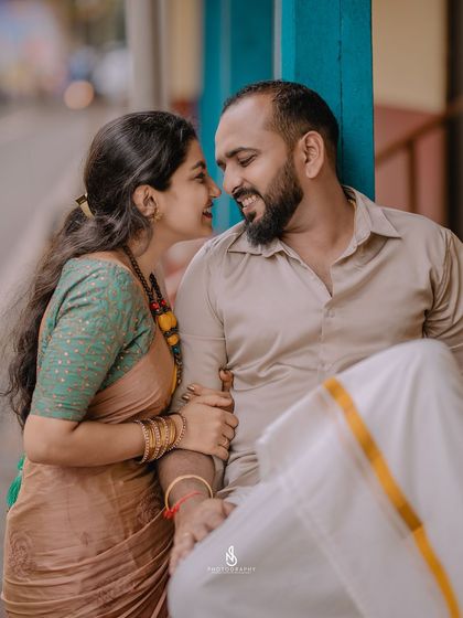 A close-up capturing a loving gaze. The pop of blue from the pillar adds a nice touch of color to the composition.