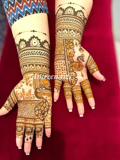 A classic bridal mehandi design with a modern twist. The patterns are traditional, featuring peacocks and lotuses, but arranged in a contemporary layout.