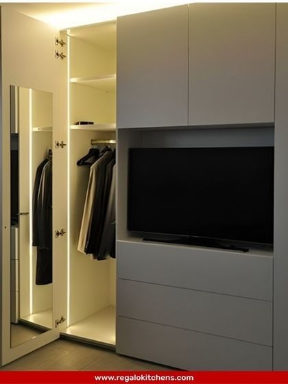 A truly multifunctional wardrobe with an integrated TV unit. This clever design saves space and creates a streamlined media and storage solution for the bedroom.