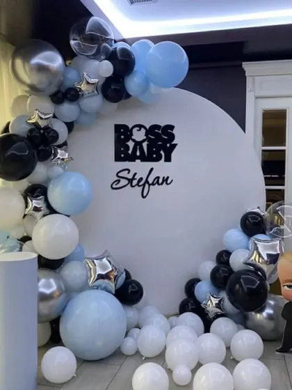 For a fun and stylish party, I can create character-themed decorations like this "Boss Baby" setup. It includes a personalized round backdrop, a modern black, blue, and silver balloon arch, and a life-sized character cutout for the perfect photo opportunity.