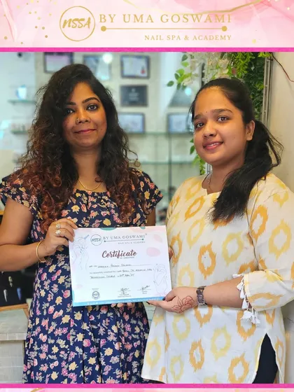 Vanshika proudly displays her certificate. Her dedication in the weekend batch has paid off, and she is now a certified nail artist.