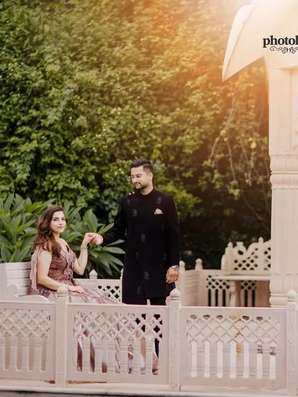 A regal shot of the couple at LP Vilas, Dehradun. The groom leads the bride, creating a sense of classic romance amidst the venue's beautiful architecture.