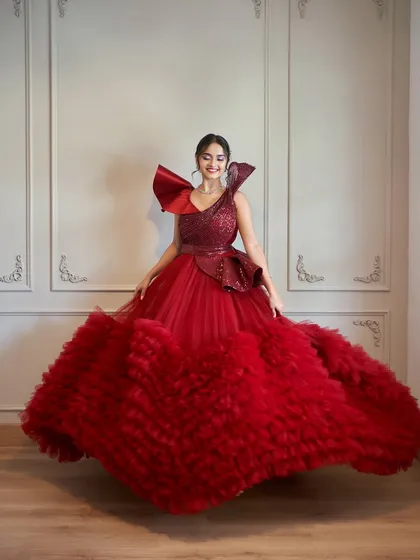 Our Veronica gown is a showstopper. This dramatic red dress features a sequined bodice and a massive ruffled tulle skirt for the ultimate glam shot.